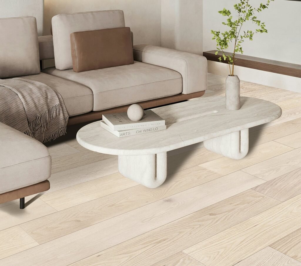 Light wide plank oak flooring in a modern living room with dark furniture and large windows